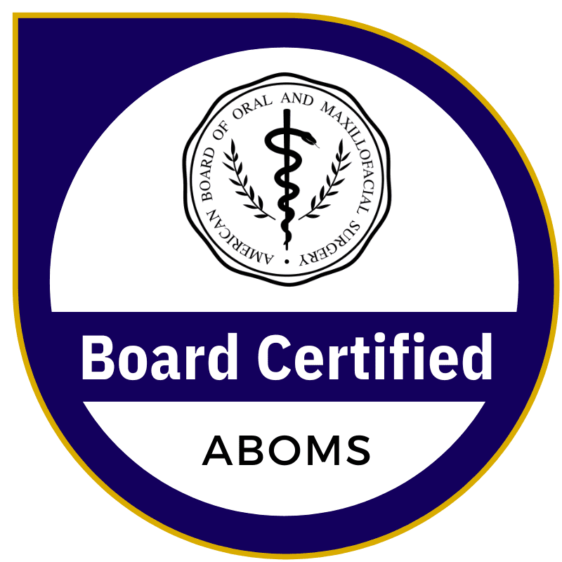 Seal featuring a caduceus symbol surrounded by text, "AMERICAN BOARD OF ORAL AND MAXILLOFACIAL SURGERY." Below, "Board Certified" appears prominently, followed by "ABOMS" in a circular design with a blue border.