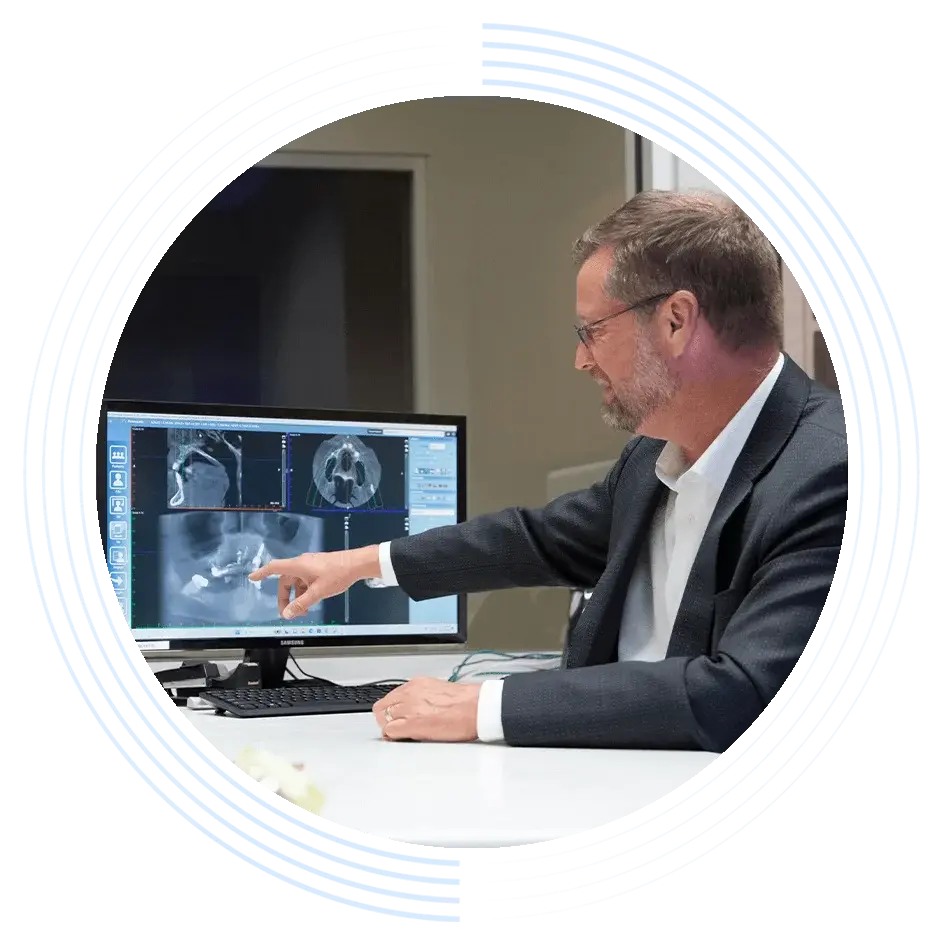 Oral surgeon reviewing dental scan results during a patient consultation