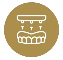 Gold circular icon with white line drawing of a set of dentures beneath a rinsing nozzle, droplets and upward arrows
