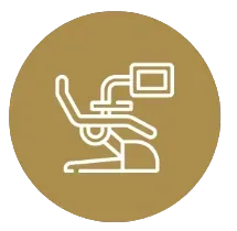 White line-icon of a dental chair with an attached monitor centered on a gold circular background.