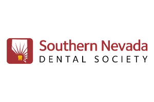 A maroon logo features a yellow tooth with white lines in a square, accompanied by text reading: “Southern Nevada Dental Society” against a transparent background.